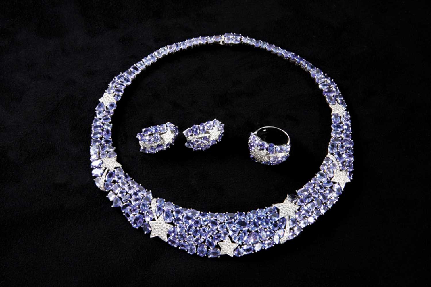 Lot 19 - 18ct white gold tanzanite four piece ‘suite’ of jewellery consisting of a choker necklace, ring and pair of earrings