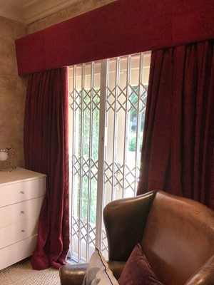 Lot 184 - A pair of red crushed velvet curtains with matching pelmet