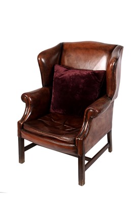 Lot 48 - A George III style brown leather wing-back armchair