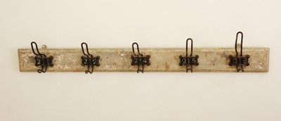 Lot 62 - A distressed painted wood hanging coat rail