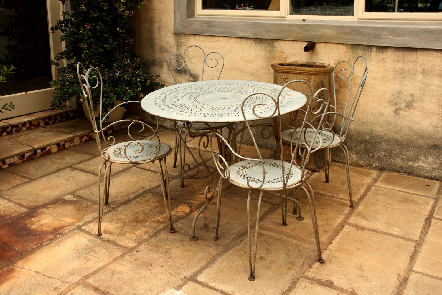 Lot 75 An outdoor metal cafe table and four chairs
