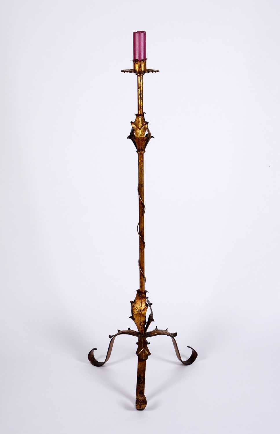 Lot 84 - A gilt metal candle stand on a scrolling tripod base