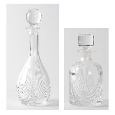 Lot 12 - ,A modern clear glass ovoid decanter with long neck, cut with bands of swirls and clear glass globular stopper and another similarly decorated mallat-shaped with clear glass drum stopper